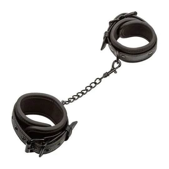 Poignets en cuir réglables noirs CALEXOTICS, accessoire BDSM ajustable avec boucle sécurisée.