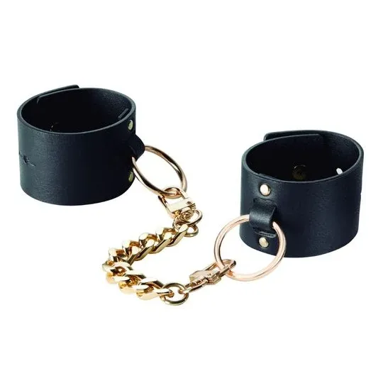 Ampie manette nere da bondage in pelle vegana, marchio Bijoux Maze, doppio uso come bracciale e manette.