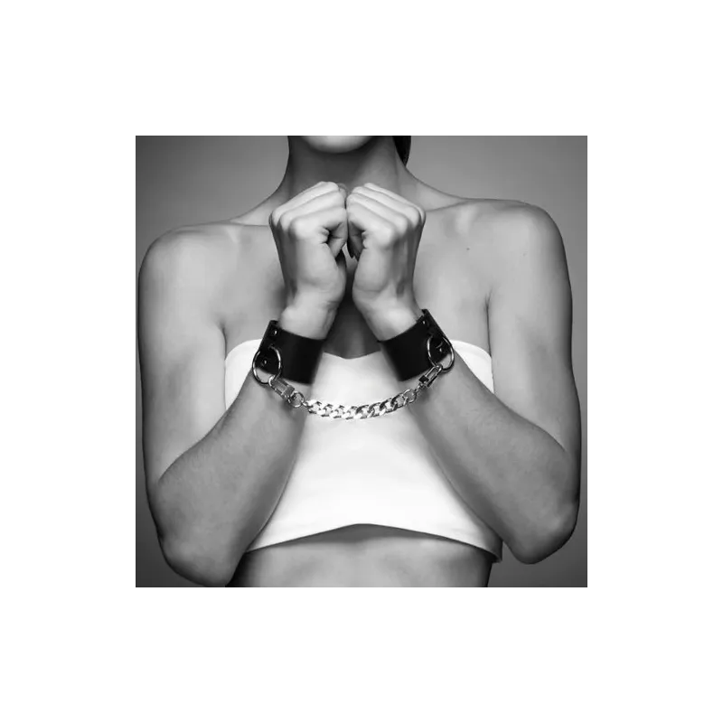 Wide black bondage cuffs in vegan leather by Bijoux Maze, dual use as bracelet and handcuffs with chain.