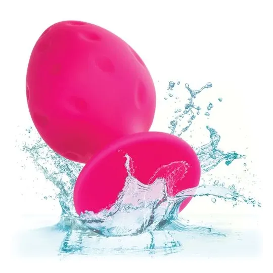 Plug anale rosa in silicone CALEXOTICS con base ventosa, tenuta sicura e texture varia per sensazioni intense.